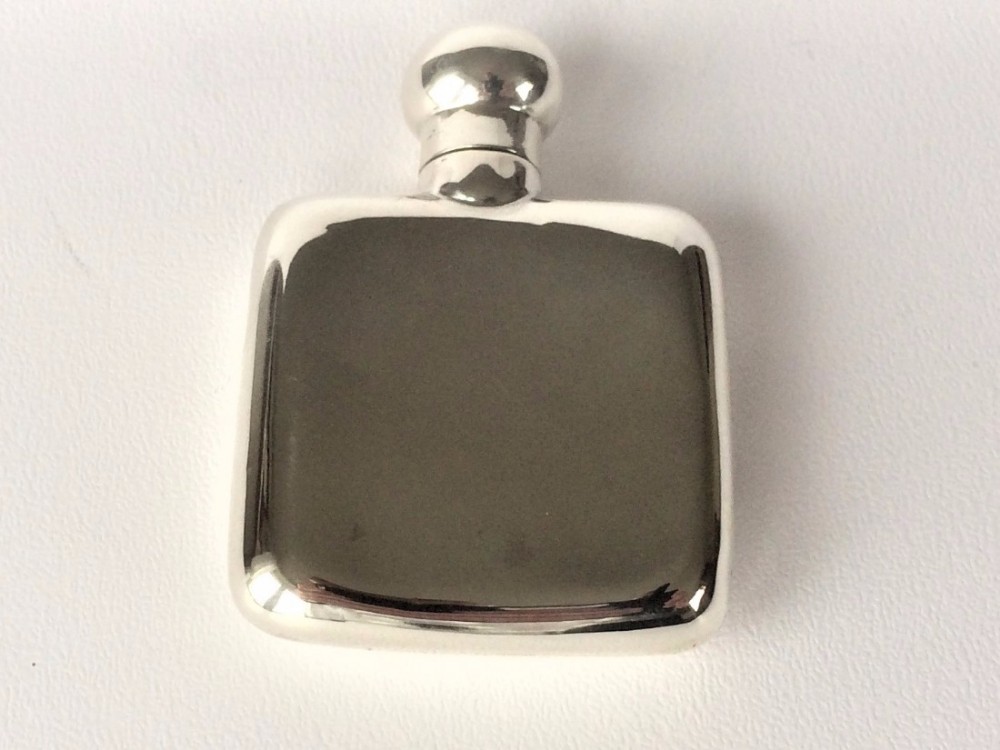 A small 'one tot' silver hip flask.