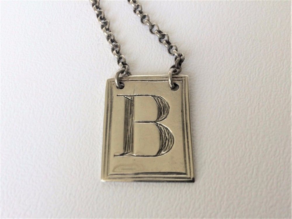 A Georgian silver 'B' Brandy decanter label.