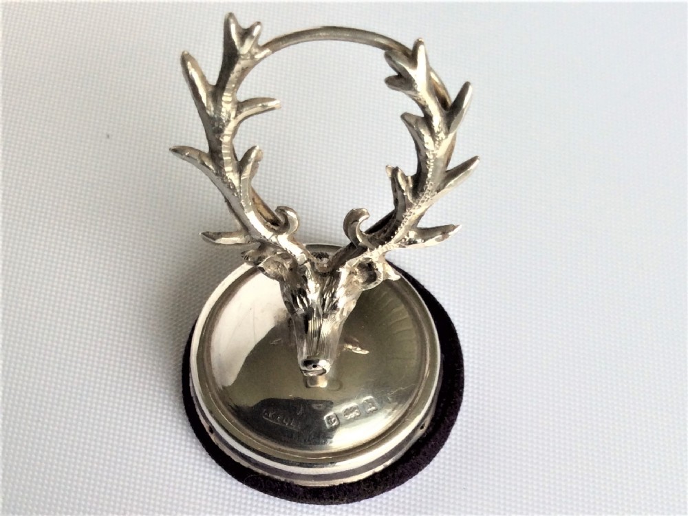 An unusual stag's head silver card/menu holder.
