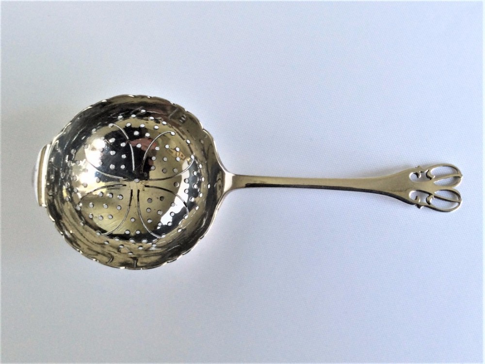 A delightful Art Nouveau silver tea strainer