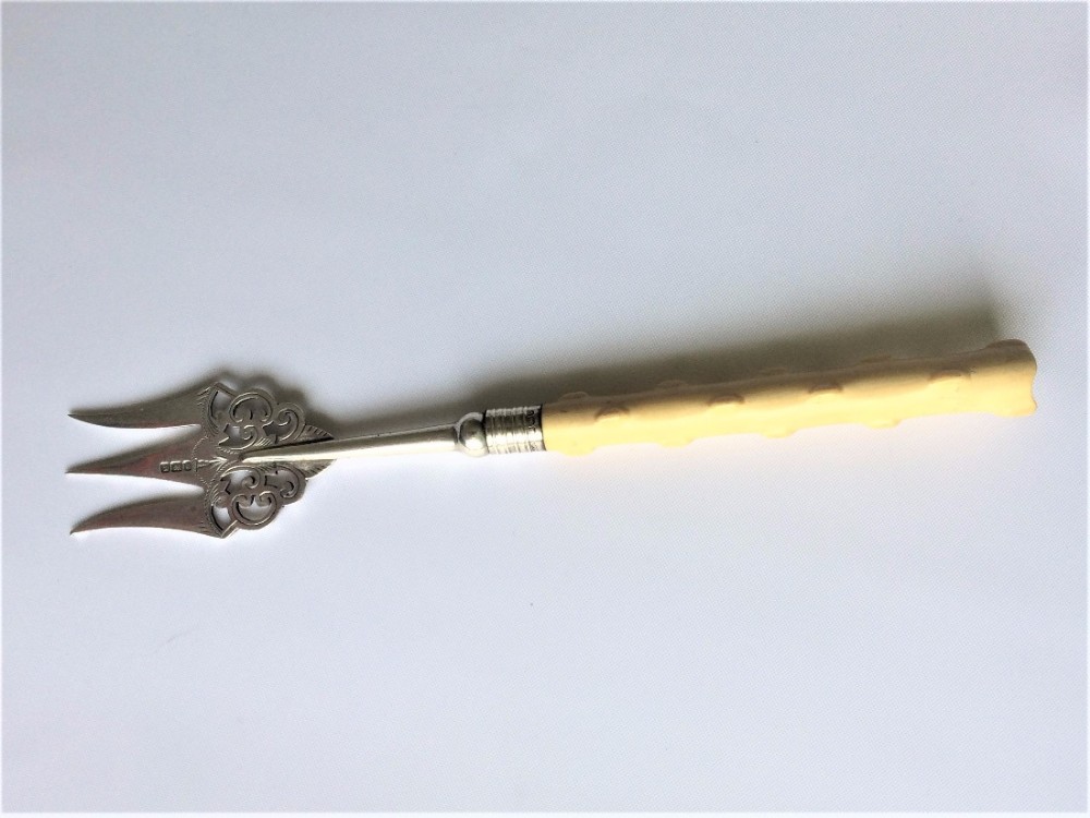 A charming Victorian silver serving fork.