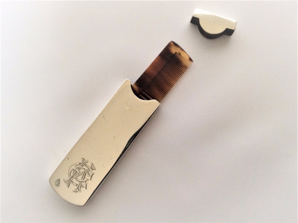 A rare Edwardian silver travelling moustache comb.