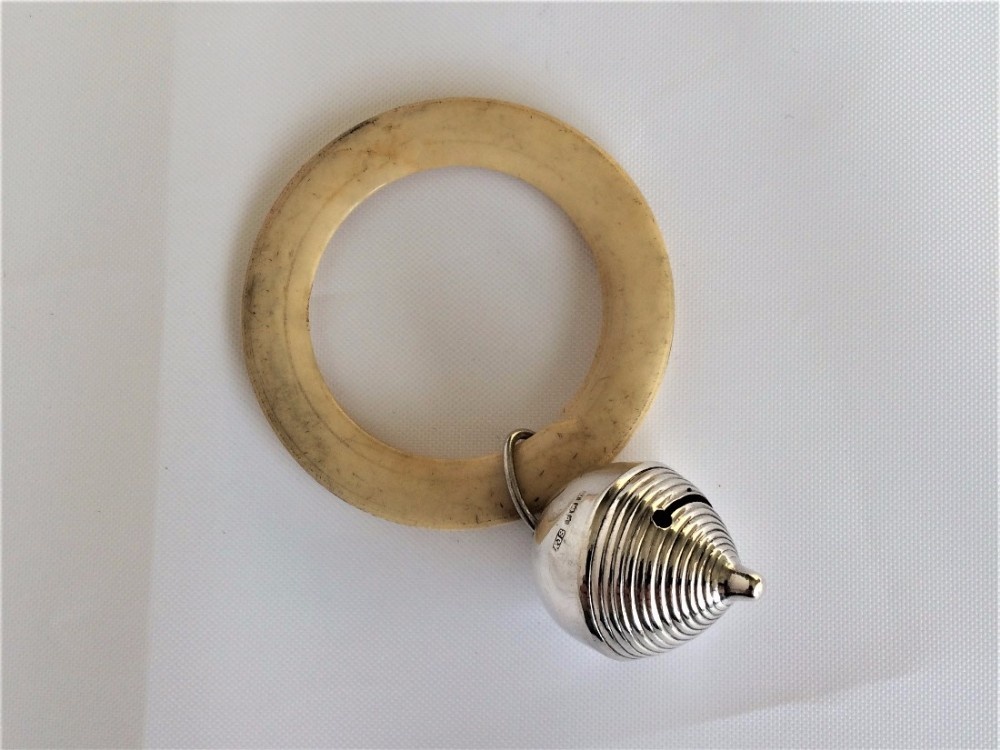 A charming silver baby's rattle and teether.