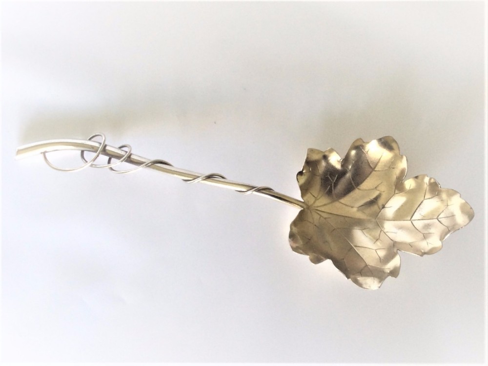 A Sterling silver naturalistic fruit or dessert serving spoon.