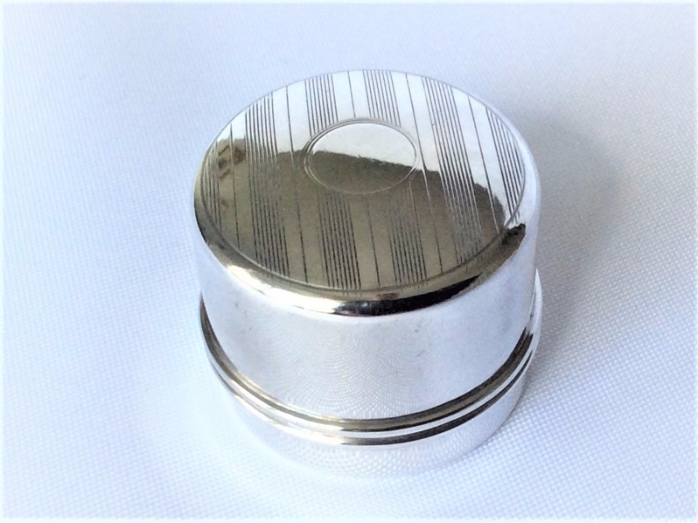 A stylish engine turned silver ring box.
