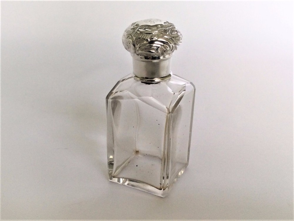 A charming silver mounted cologne bottle & sprinkler.