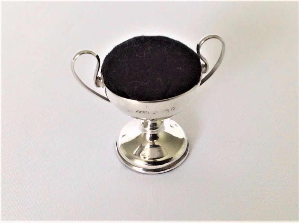 An unusual novelty silver 'trophy cup' pin cushion.