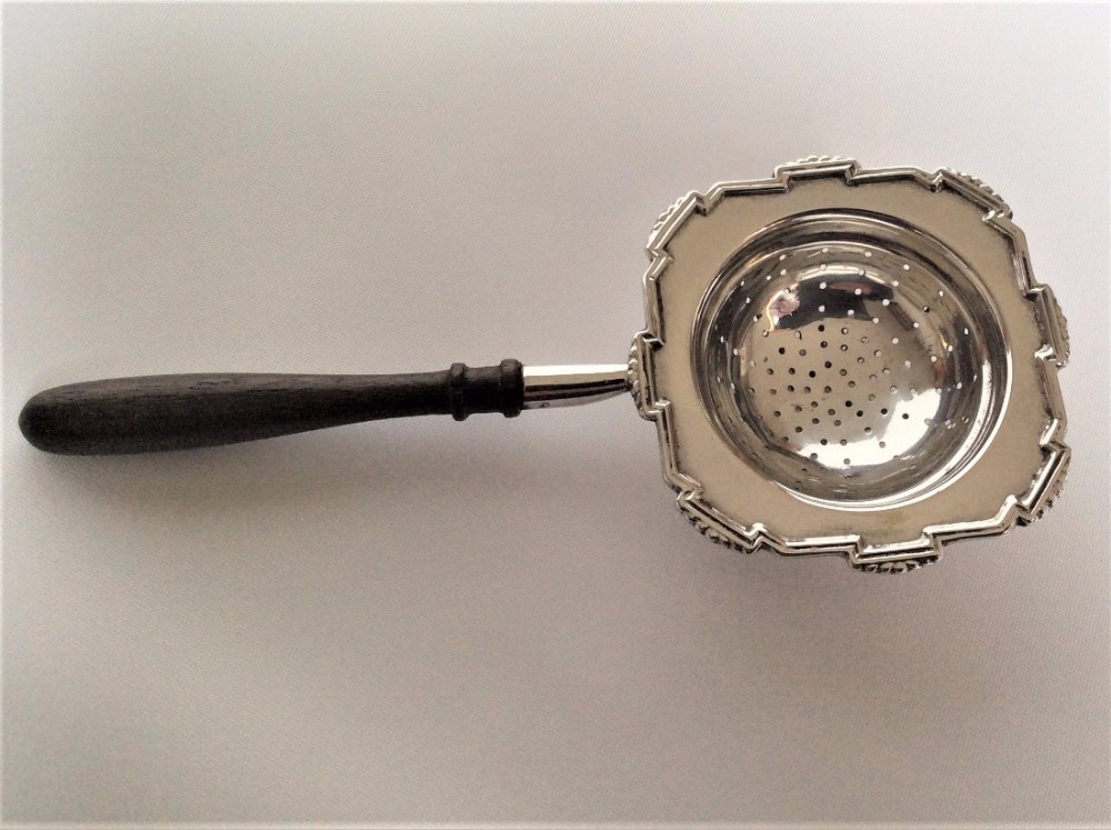 A stylish Art Deco silver tea strainer.