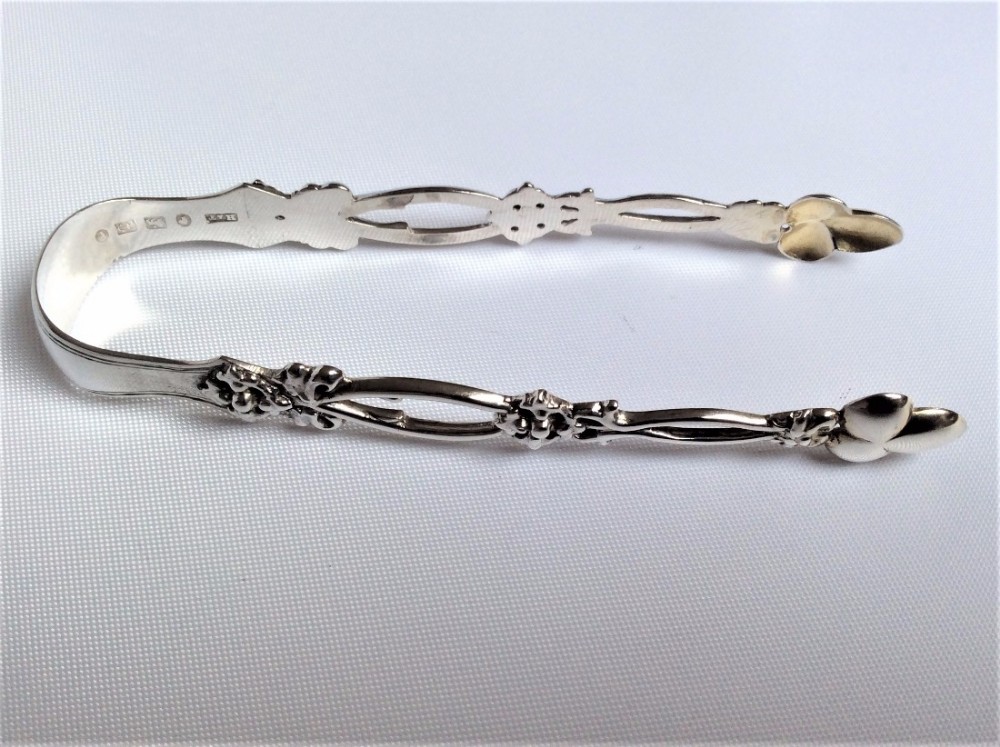 A lovely pair of pierced Victorian silver tongs.
