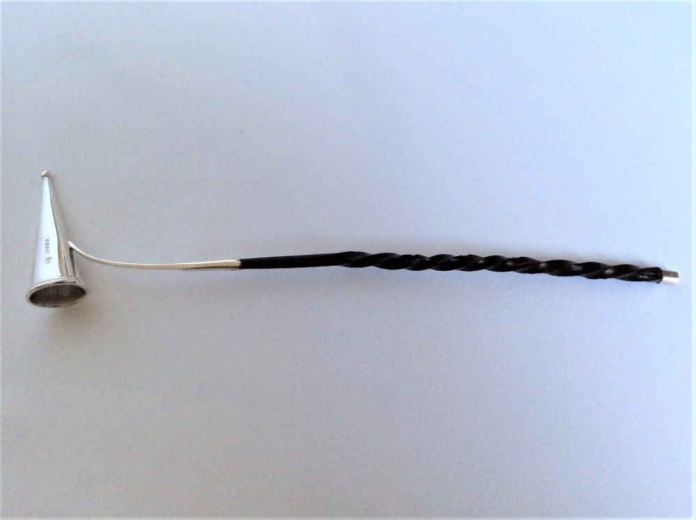 An extremely rare Victorian silver candle snuffer.