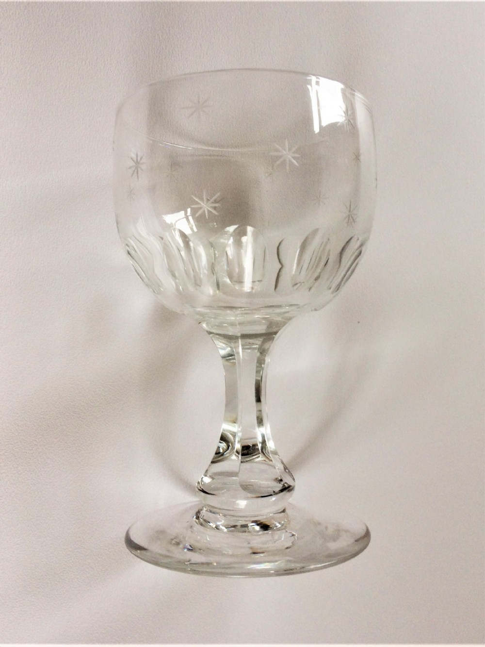 A late Victorian star etched wine goblet.