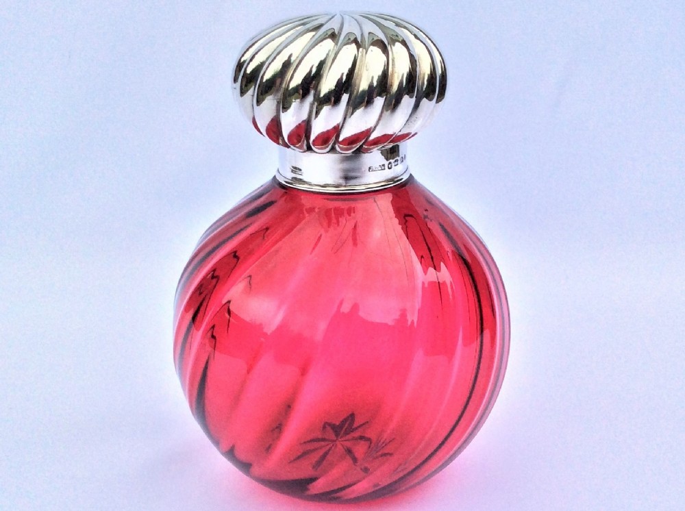 A fabulous Victorian silver mounted cranberry cologne bottle.