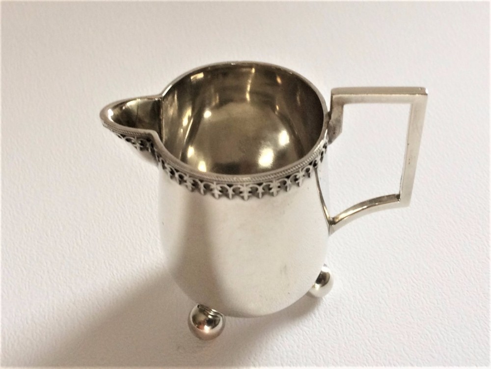A tiny one serving German silver cream jug.