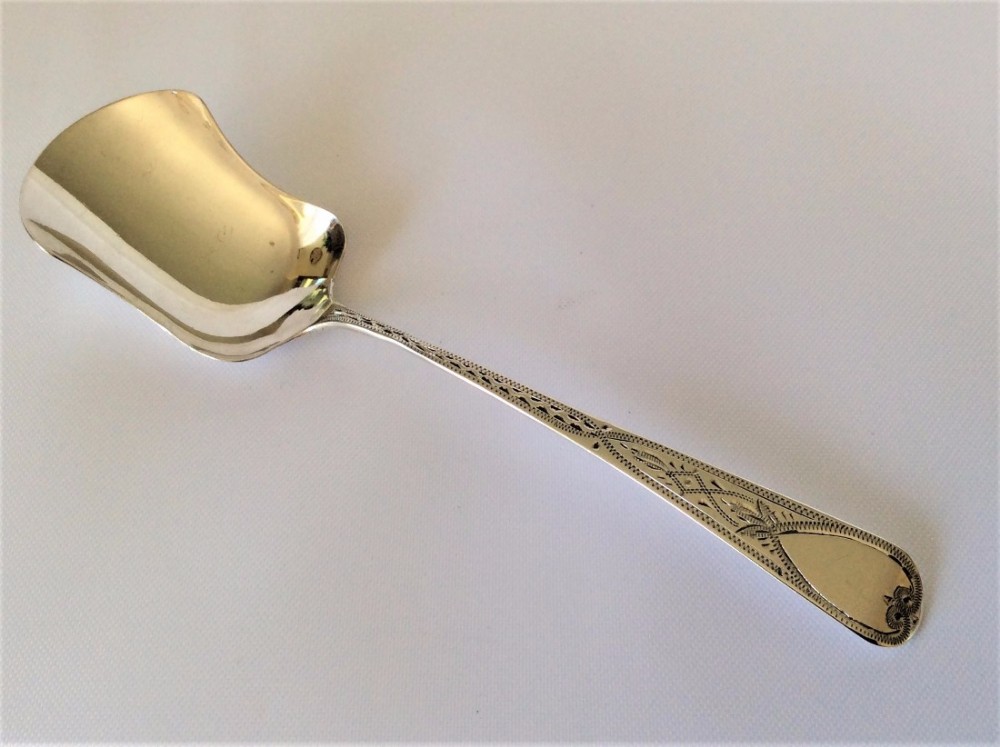 A Georgian Bright Cut silver sugar/preserve spoon.