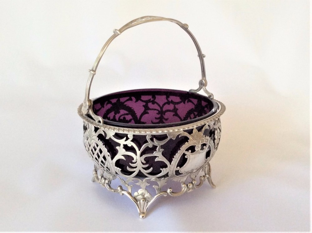 A stunning Edwardian pierced silver & amethyst glass basket.