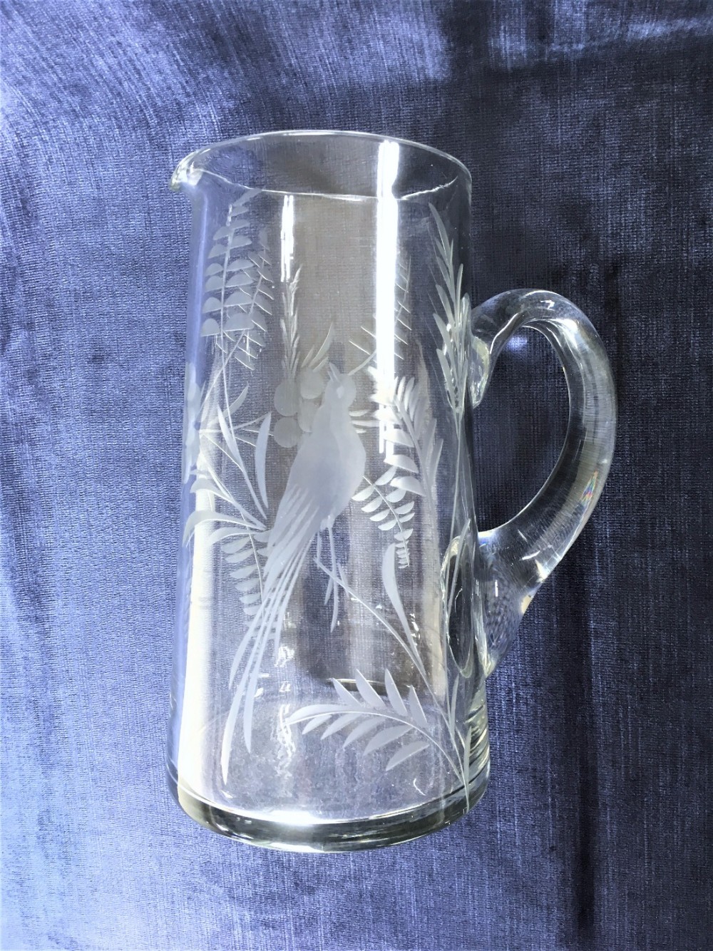 A bird engraved Edwardian glass water jug.