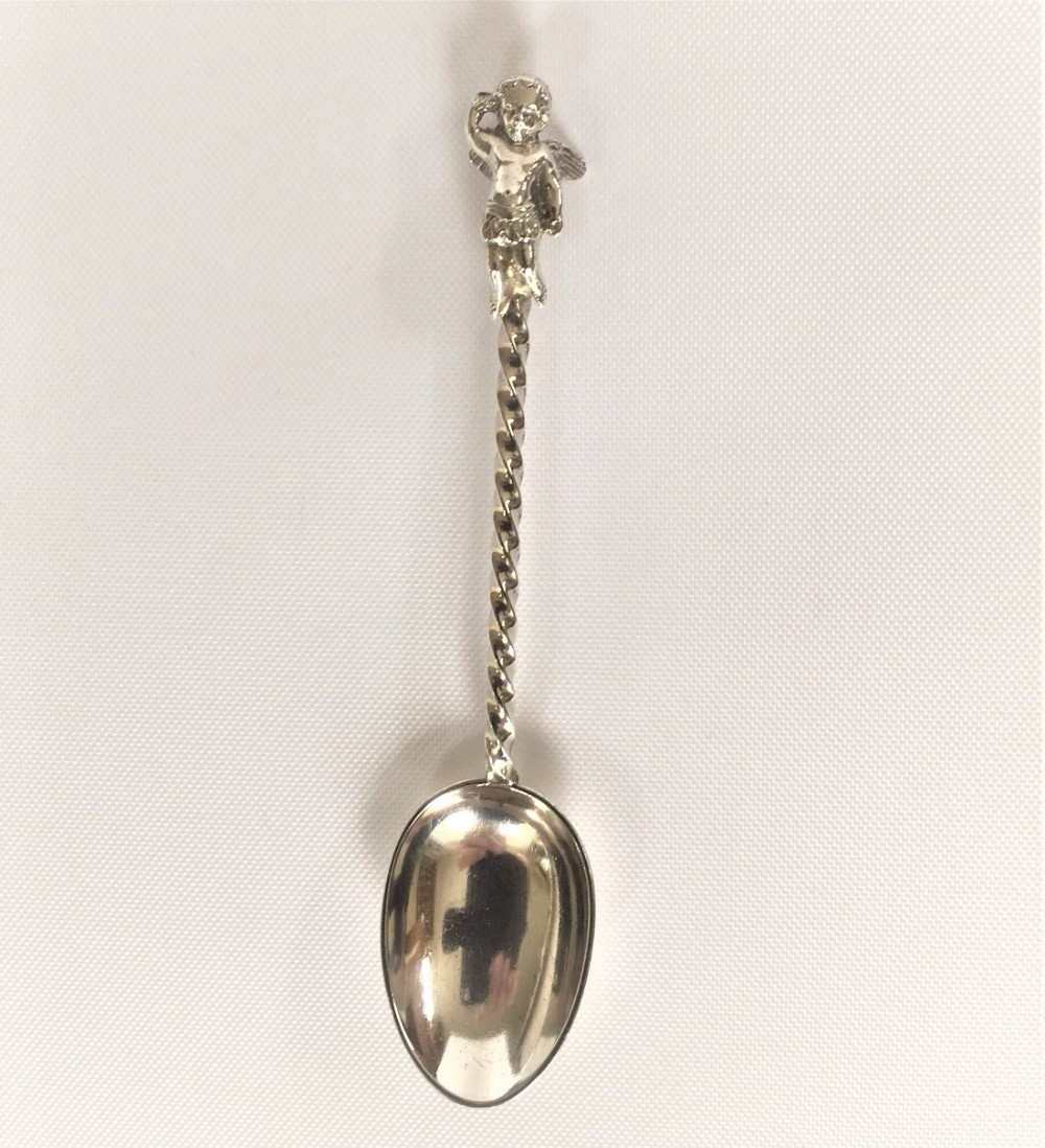 A Victorian winged cherub silver spoon.