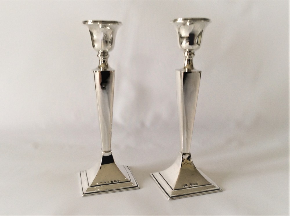 A stylish pair of George V silver candlesticks.