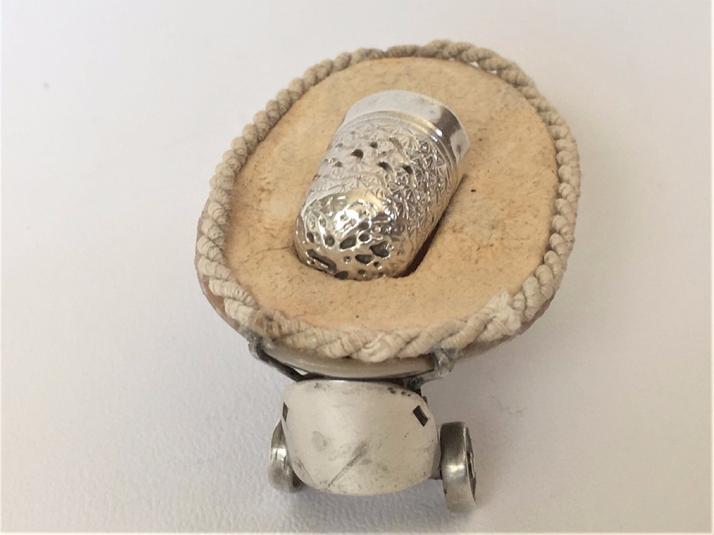 A rare Edwardian novelty silver roller skate thimble holder. View V