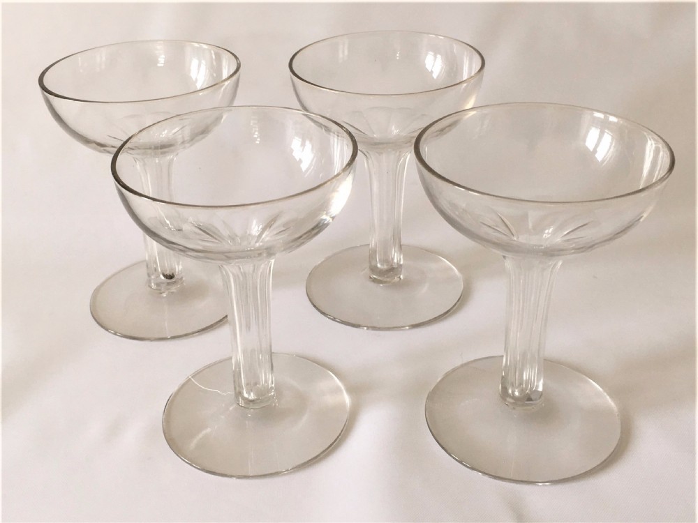 A set of four small hollow stem champagne glasses.