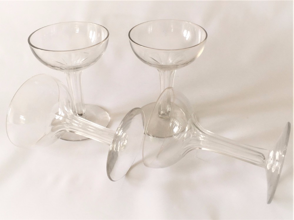 A set of four small hollow stem champagne glasses. View II