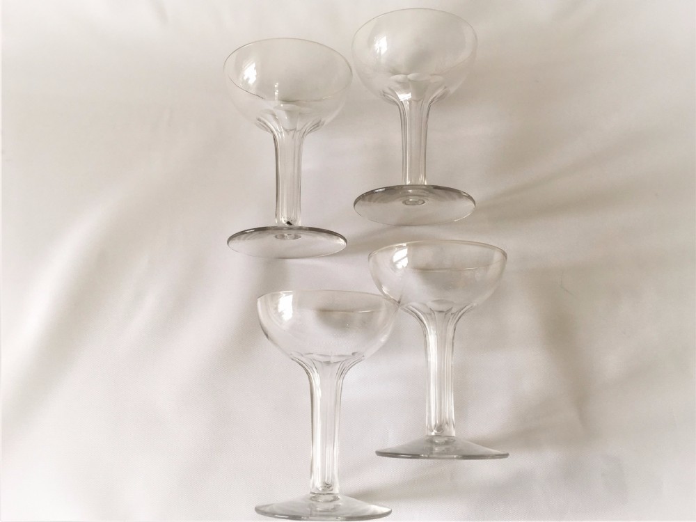A set of four small hollow stem champagne glasses. View III