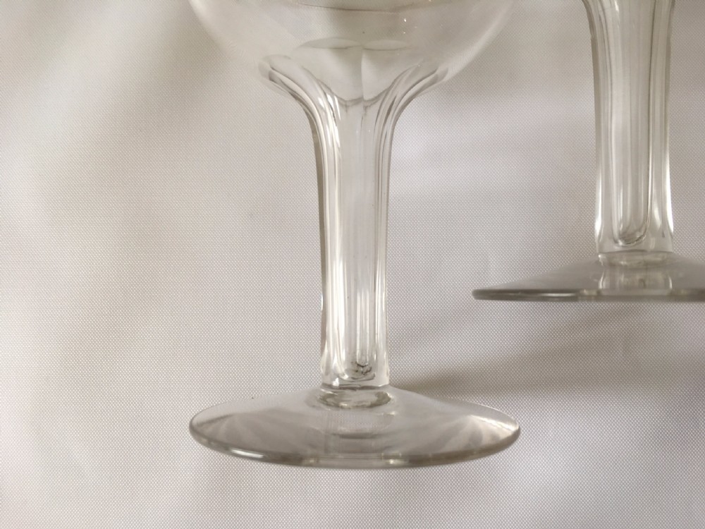 A set of four small hollow stem champagne glasses. View V