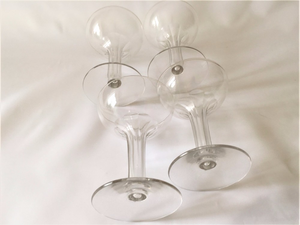 A set of four small hollow stem champagne glasses. View VI