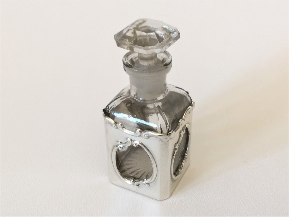 A delightful Art Nouveau silver cased scent bottle.