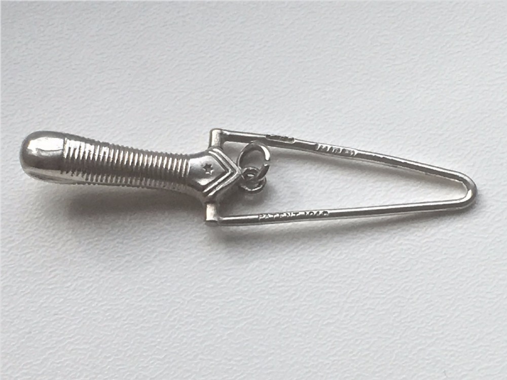 A Victorian silver ribbon threader.