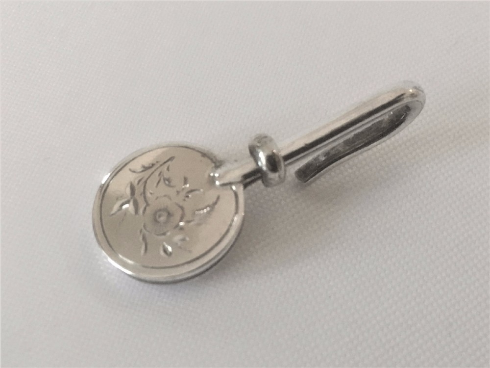 A Victorian silver ribbon threader. View VI