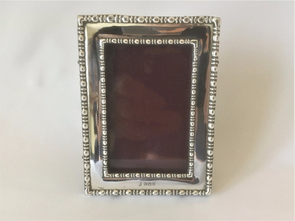 A charming small silver photo frame. View III