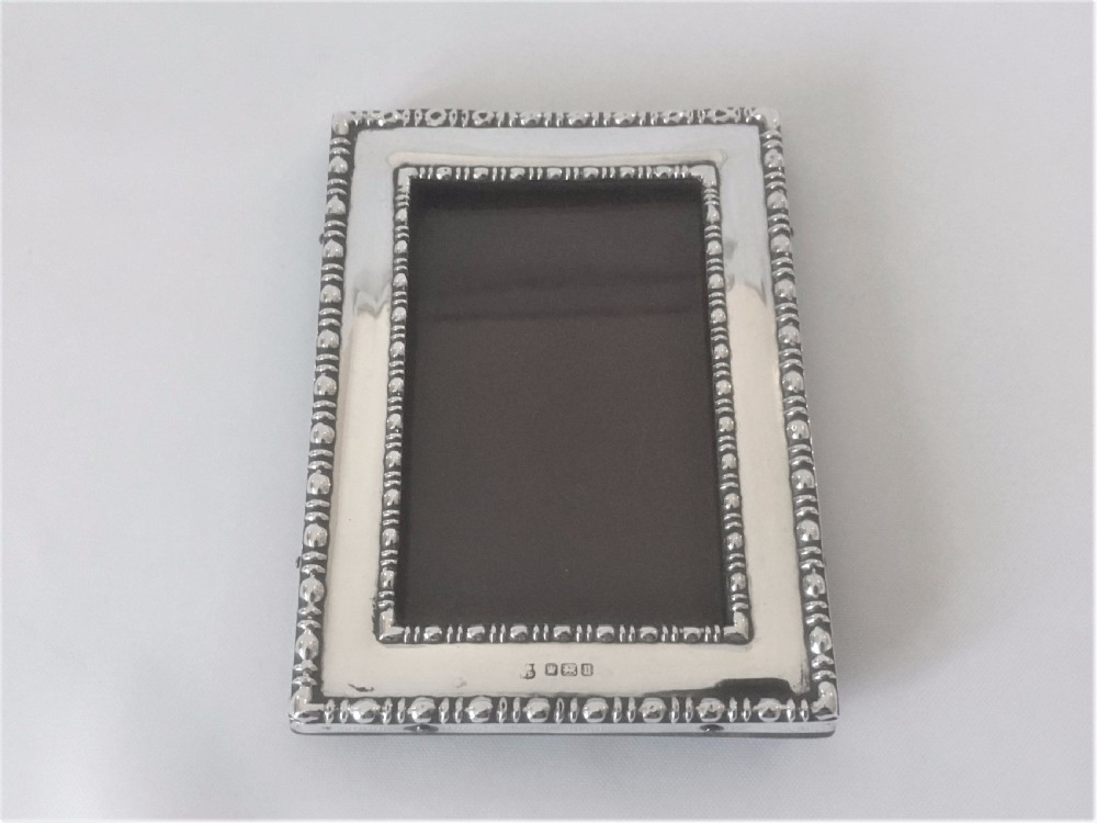 A charming small silver photo frame. View VI