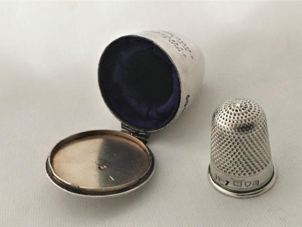 An early Victorian silver thimble case and thimble.