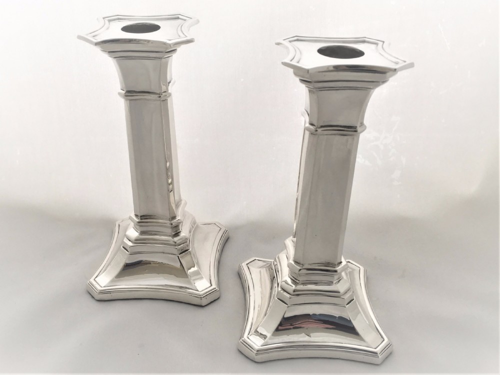 A handsome pair of Edwardian silver candlesticks.