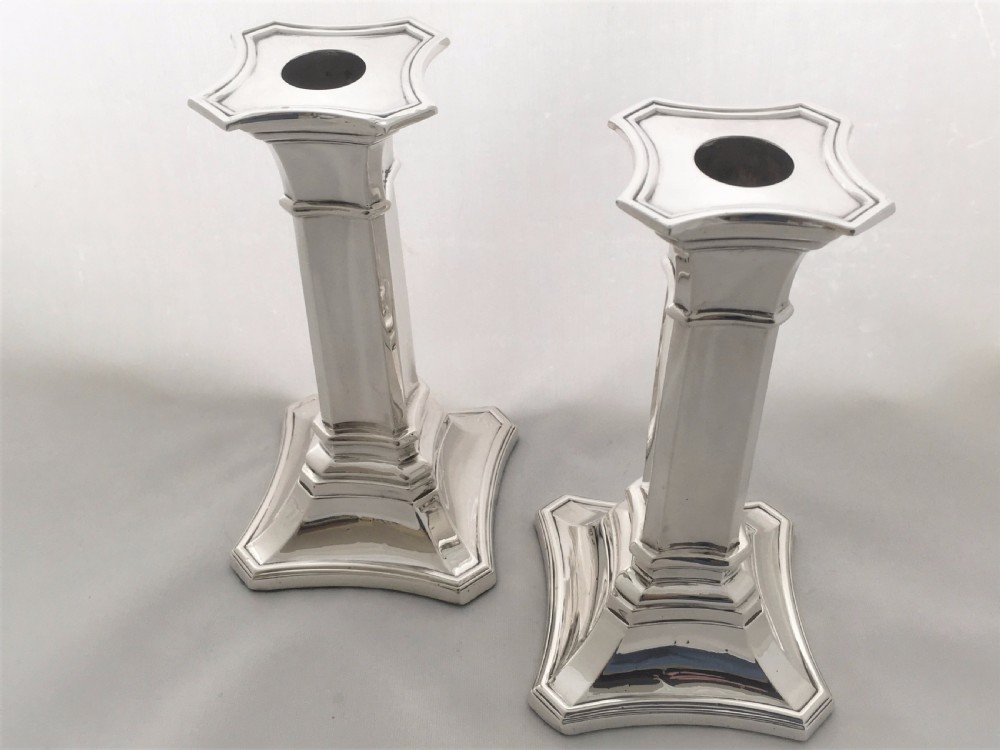 A handsome pair of Edwardian silver candlesticks. View II