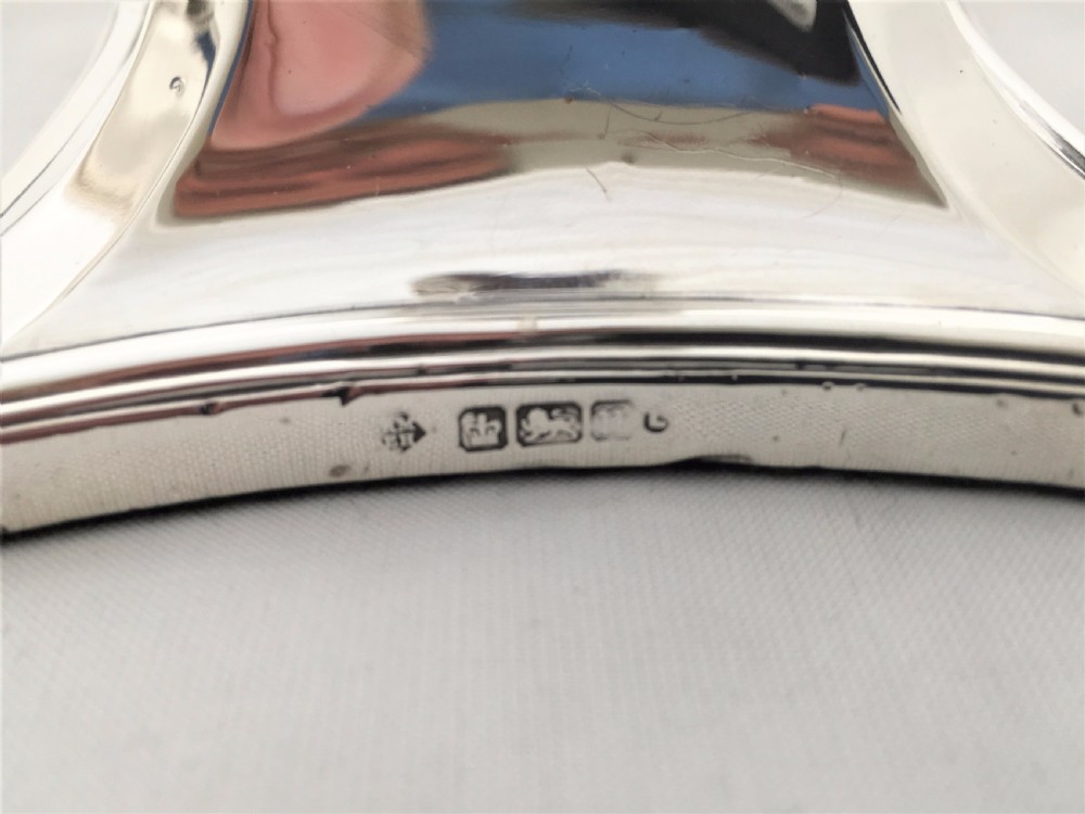 A handsome pair of Edwardian silver candlesticks. View V