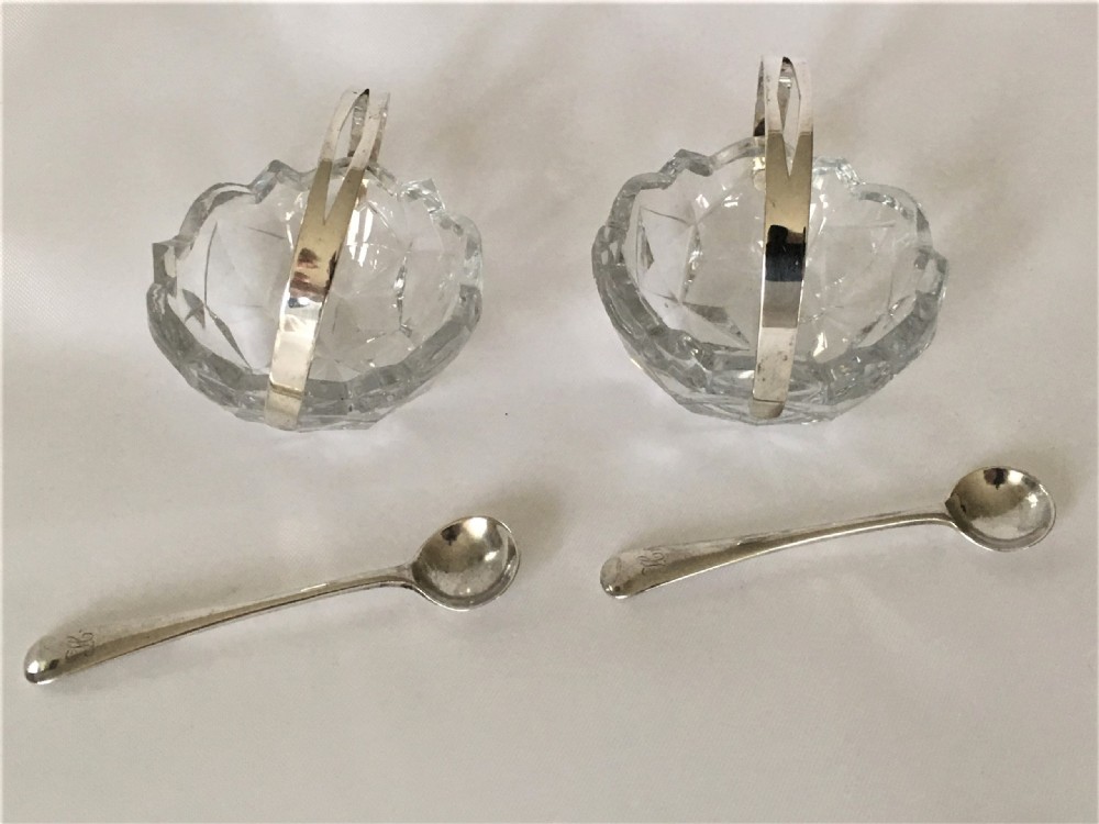 A pair of cut glass condiment baskets with silver spoons. View II