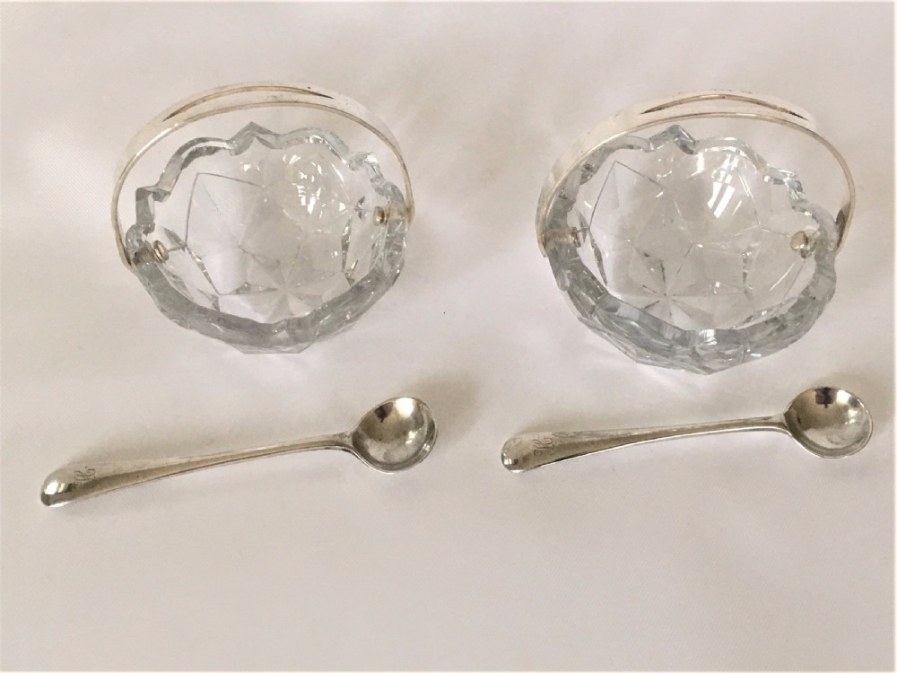 A pair of cut glass condiment baskets with silver spoons. View III