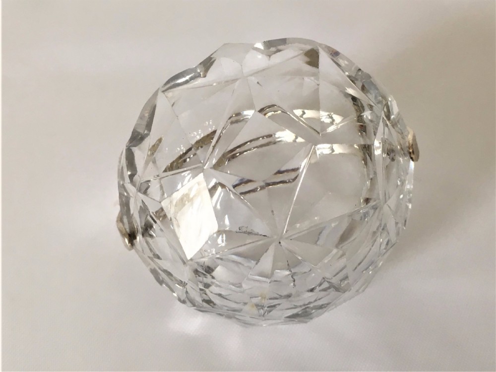 A pair of cut glass condiment baskets with silver spoons. View V