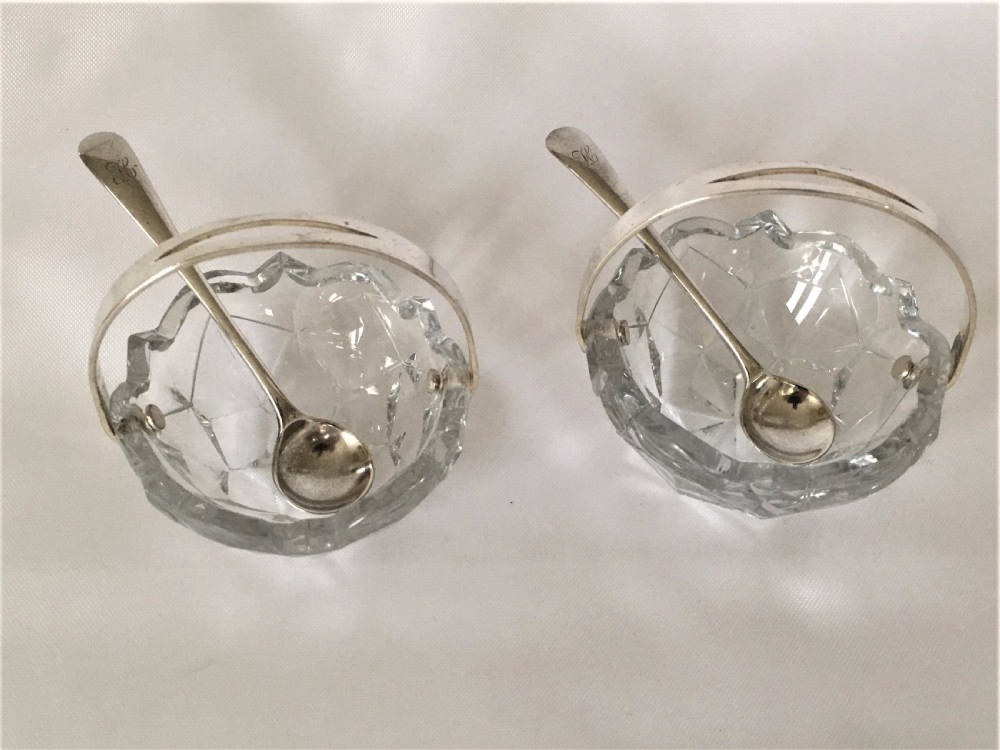 A pair of cut glass condiment baskets with silver spoons. View VI