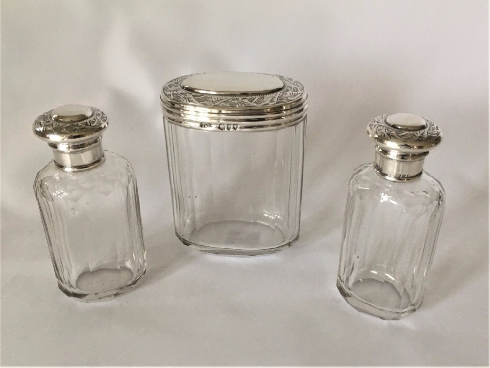 A set of three Victorian silver mounted dressing table jars.
