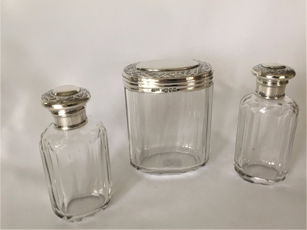 A set of three Victorian silver mounted dressing table jars. View II