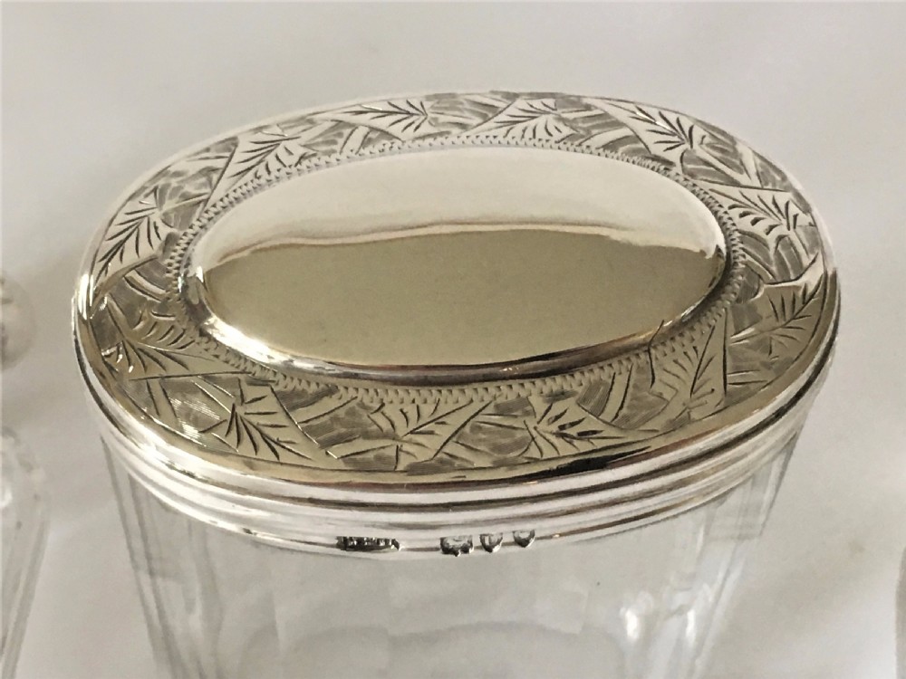 A set of three Victorian silver mounted dressing table jars. View V