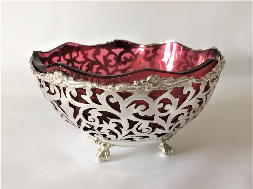 A stunning Edwardian pierced silver and cranberry bowl.