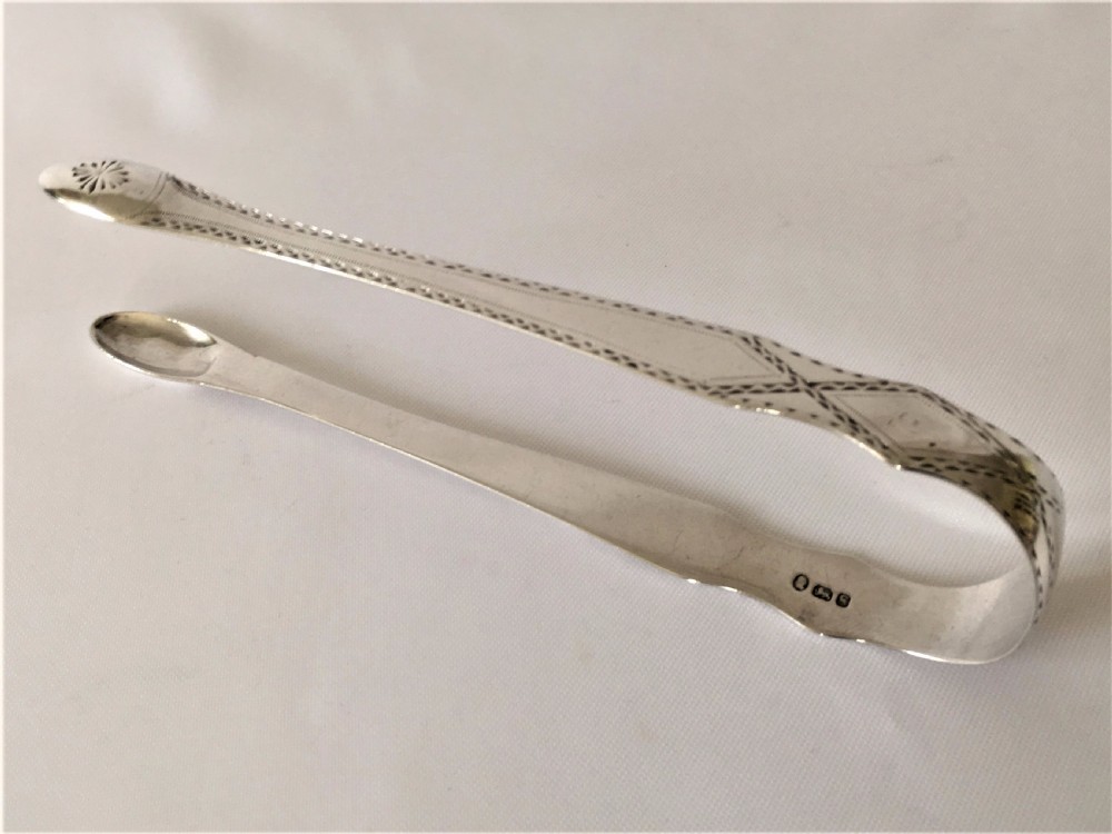 A gorgeous pair of 18th Century silver tongs.