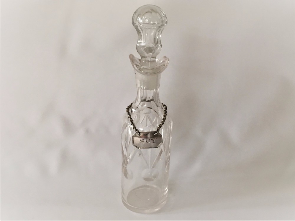 A rare Edwardian soy bottle with hallmarked silver label.