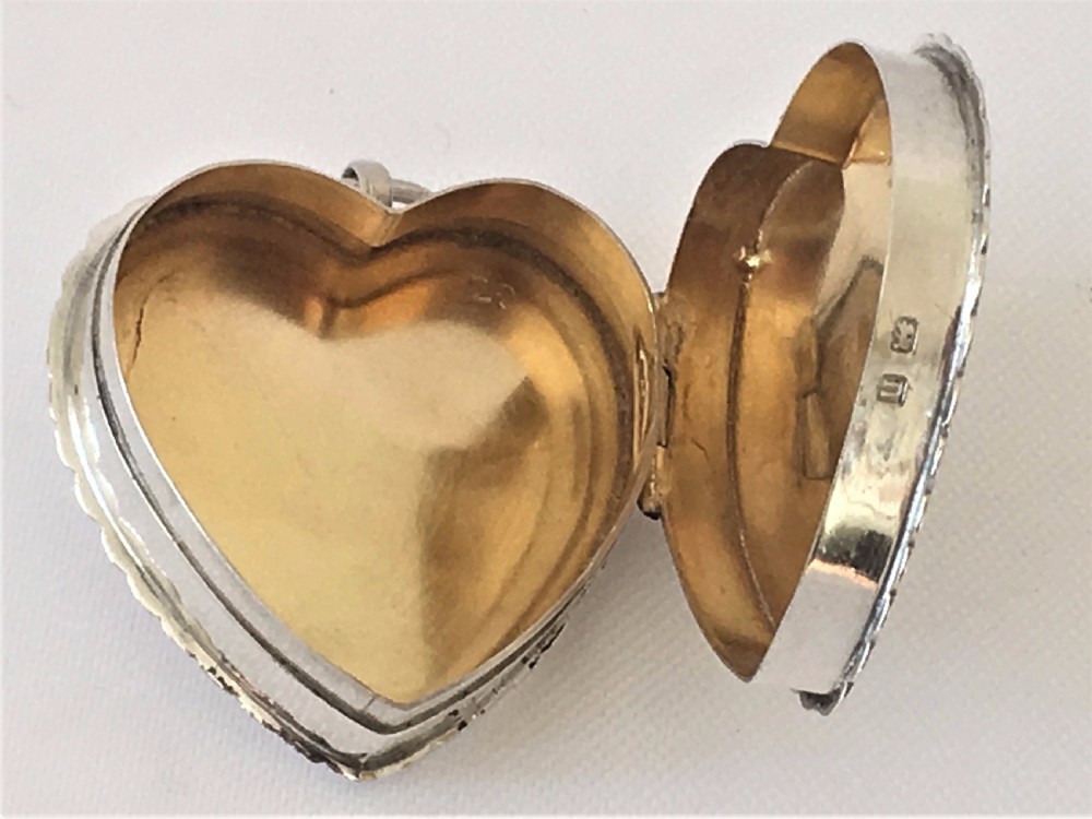 An engraved silver heart shaped pillbox. View V