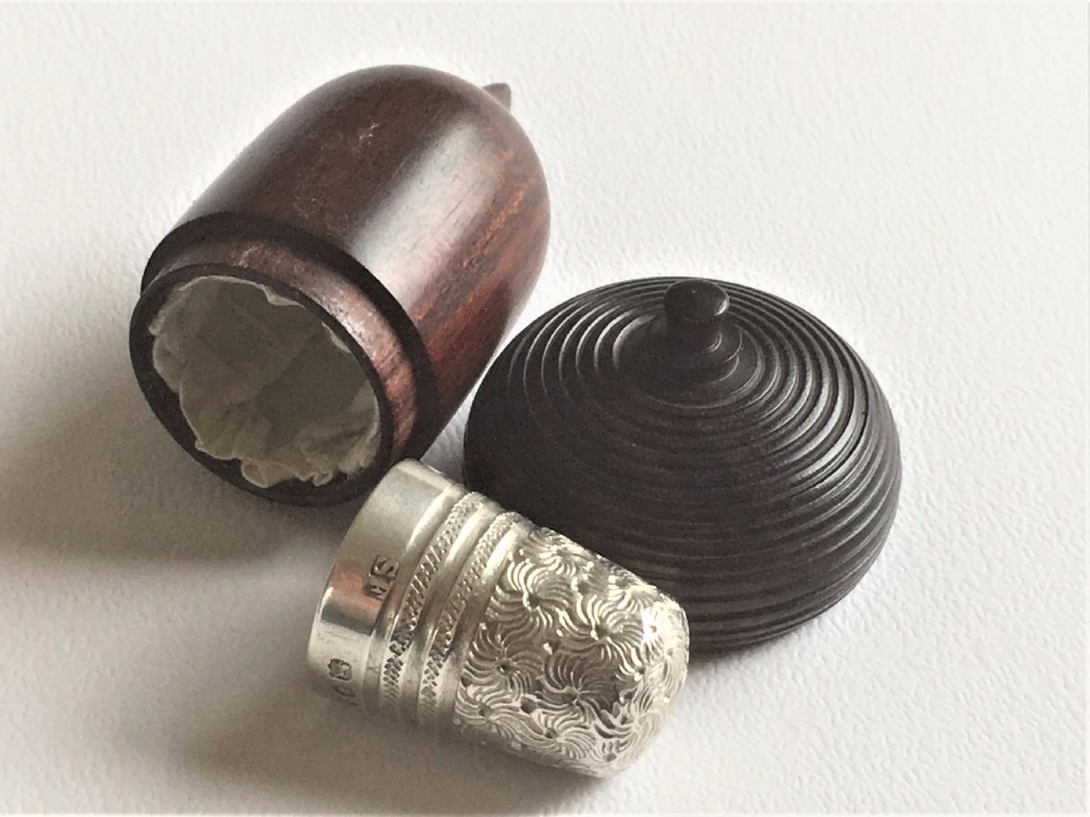 A gorgeous Victorian silver thimble in treen acorn case.