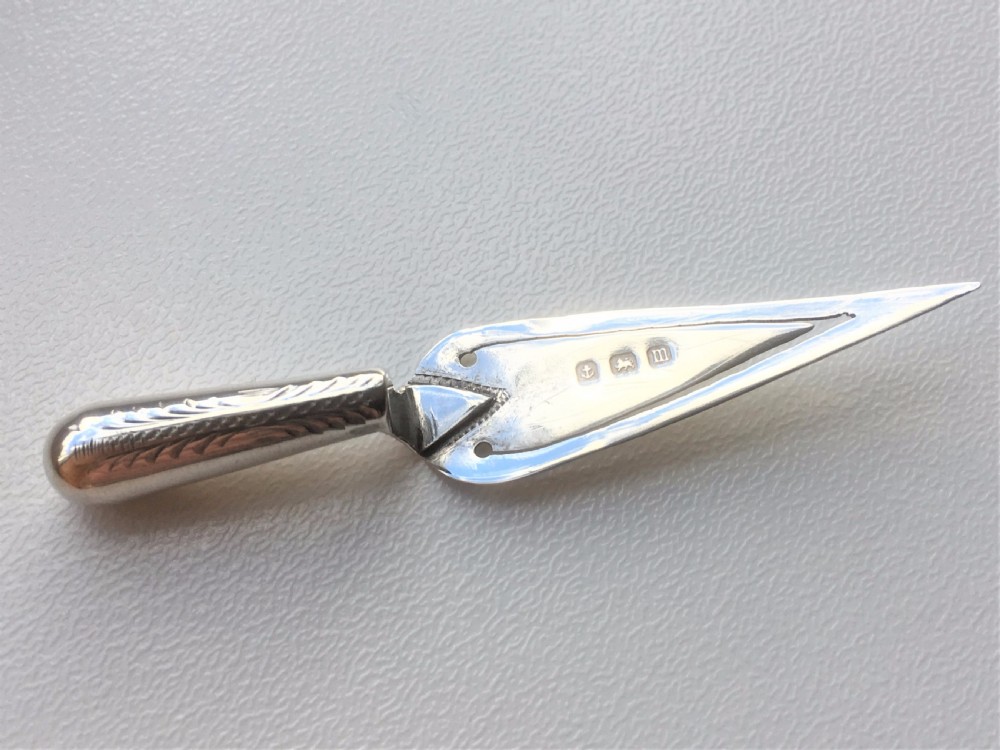 A charming Bright Cut silver trowel bookmark.